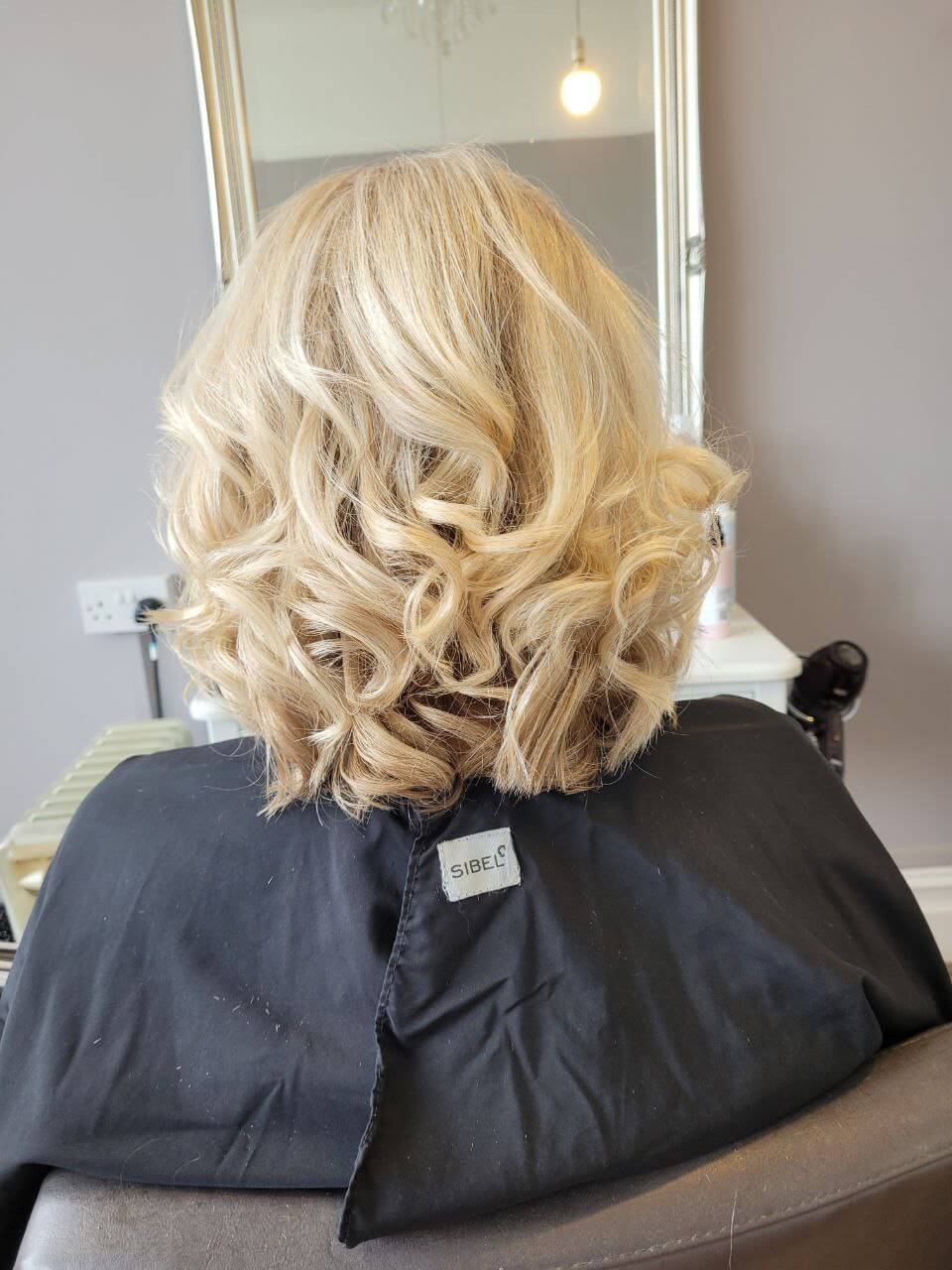 blonde hair curled and styled