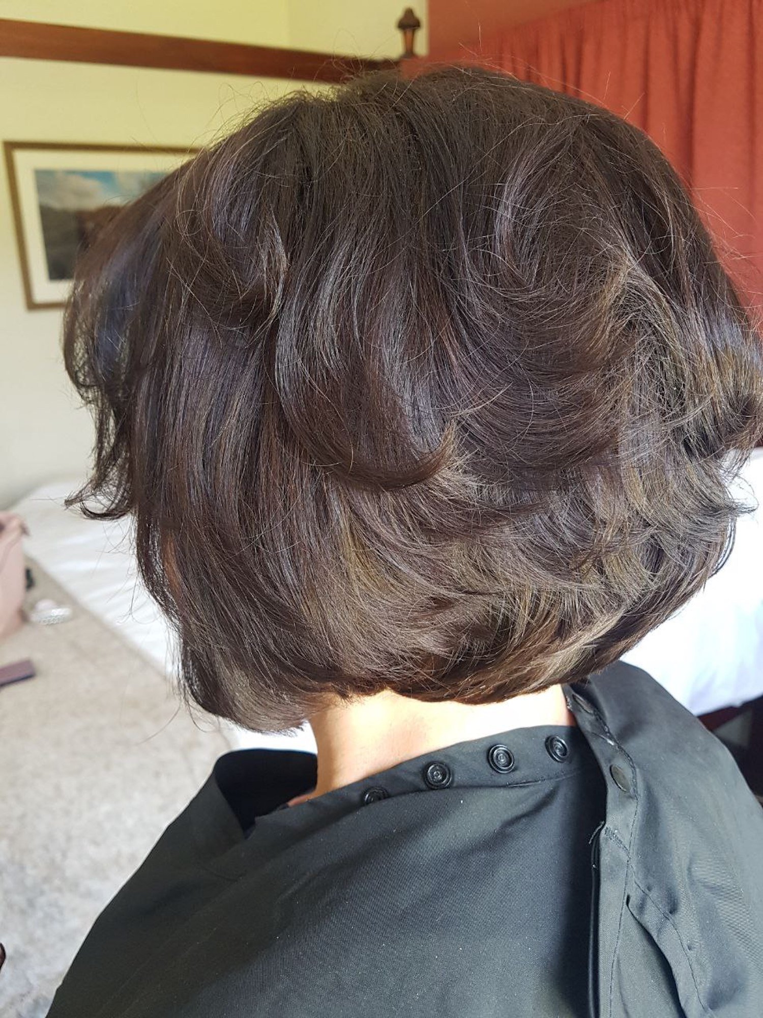 short dark bobbed hair styled